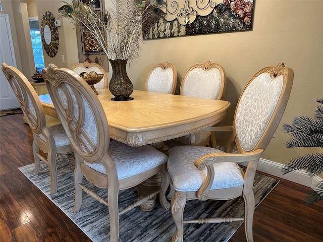 dining space with dark hardwood / wood-style flooring