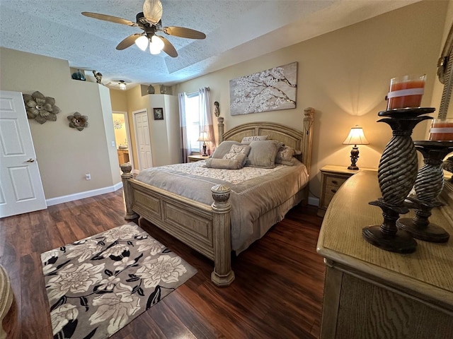 bedroom with a closet, a textured ceiling, dark hardwood / wood-style floors, and ceiling fan