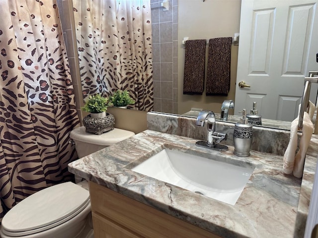 bathroom featuring vanity, a shower with curtain, and toilet