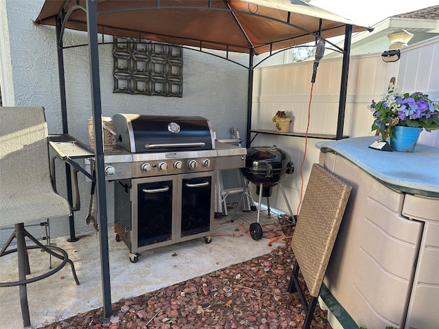 view of patio / terrace with a gazebo and a grill