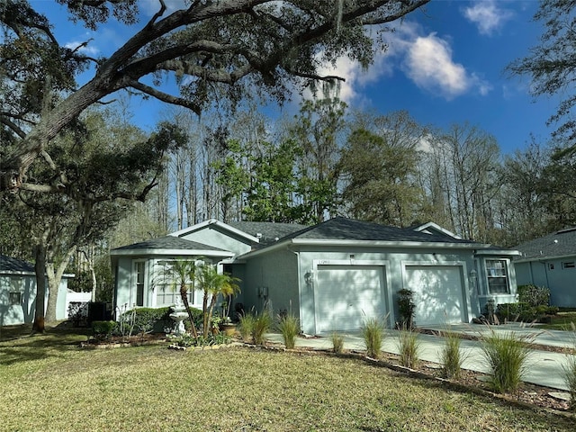 ranch-style house with an attached garage, driveway, a front lawn, and stucco siding