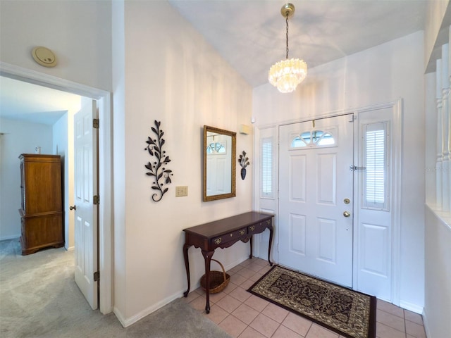 tiled foyer entrance with a chandelier