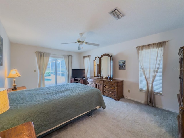 carpeted bedroom with ceiling fan and access to exterior