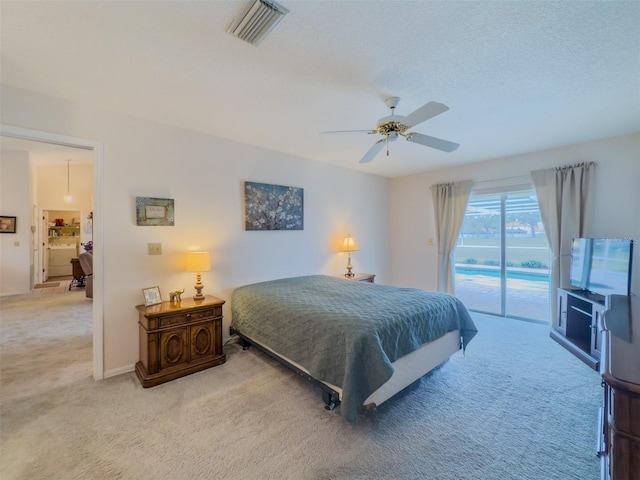 bedroom featuring ceiling fan, light colored carpet, and access to exterior