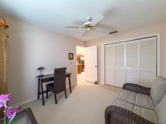 carpeted office with ceiling fan