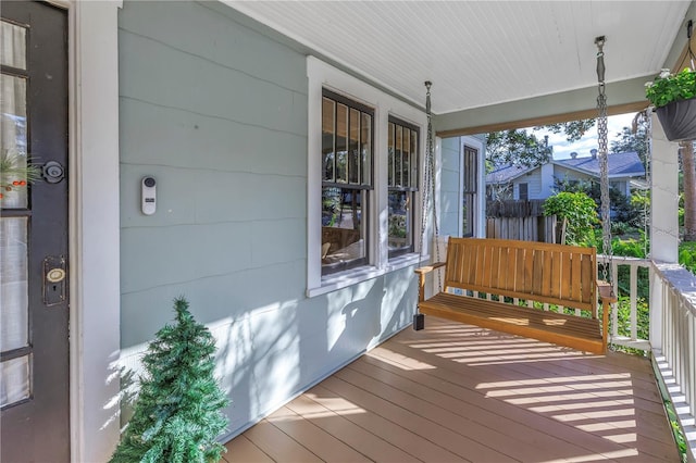 wooden terrace featuring covered porch