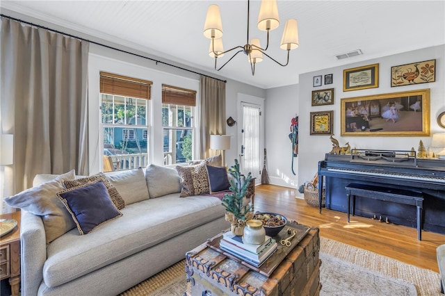 living room with wood-type flooring and an inviting chandelier