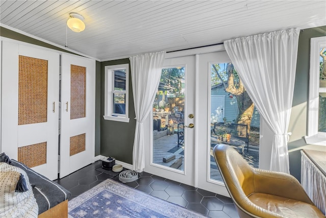 entryway featuring dark tile patterned floors and wooden ceiling