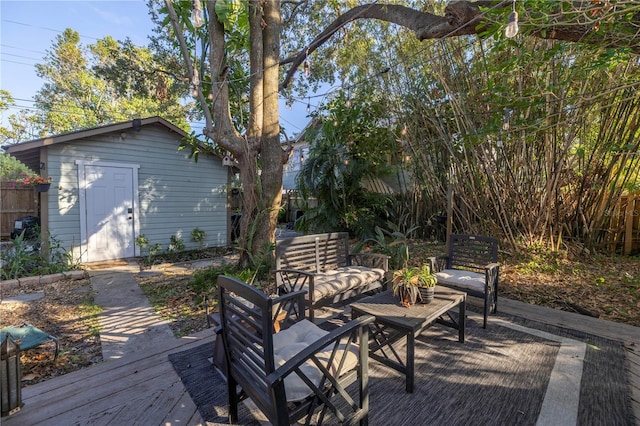 wooden deck with outdoor lounge area and a storage unit