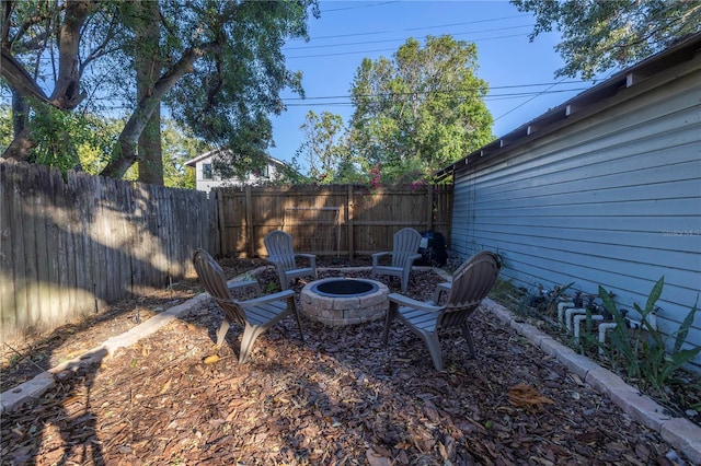 view of yard with a fire pit