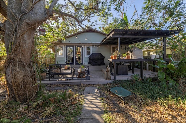 back of house featuring a pergola and a wooden deck