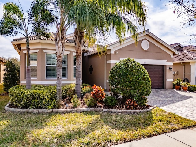 view of front facade with a garage and a front yard