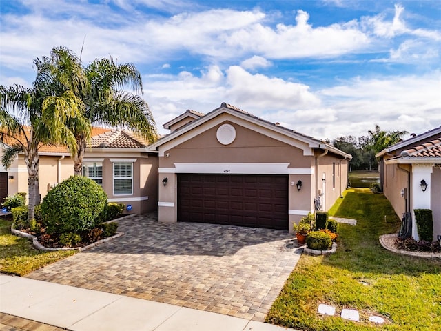 view of front of property with a garage and a front yard