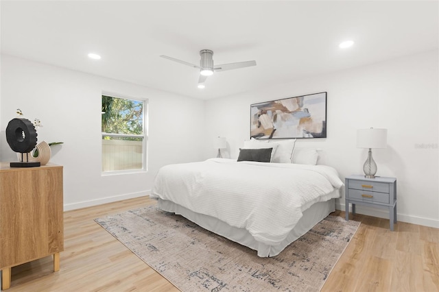 bedroom with light hardwood / wood-style floors and ceiling fan