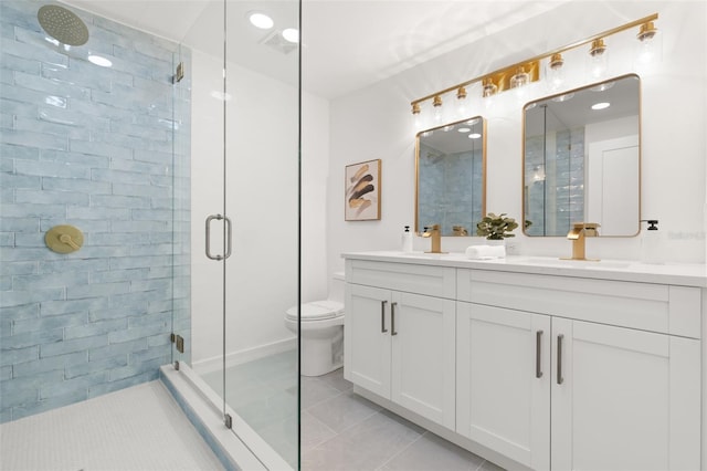 bathroom featuring tile patterned floors, a shower with door, vanity, and toilet