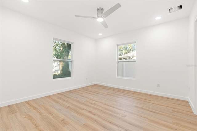 spare room featuring light hardwood / wood-style floors and ceiling fan