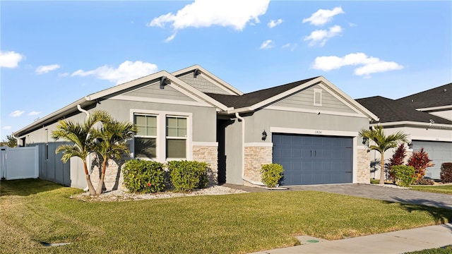 view of front of home with a front yard and a garage