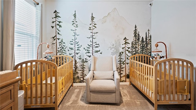 bedroom with a crib and carpet floors