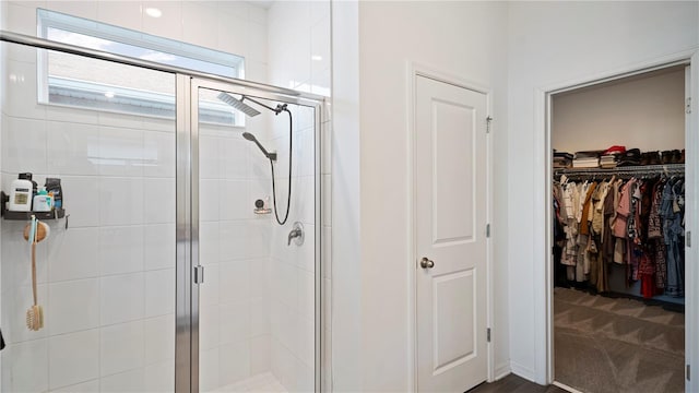 bathroom featuring a shower with shower door