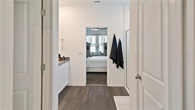 corridor featuring dark hardwood / wood-style flooring