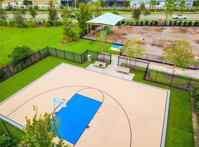 view of basketball court with a yard