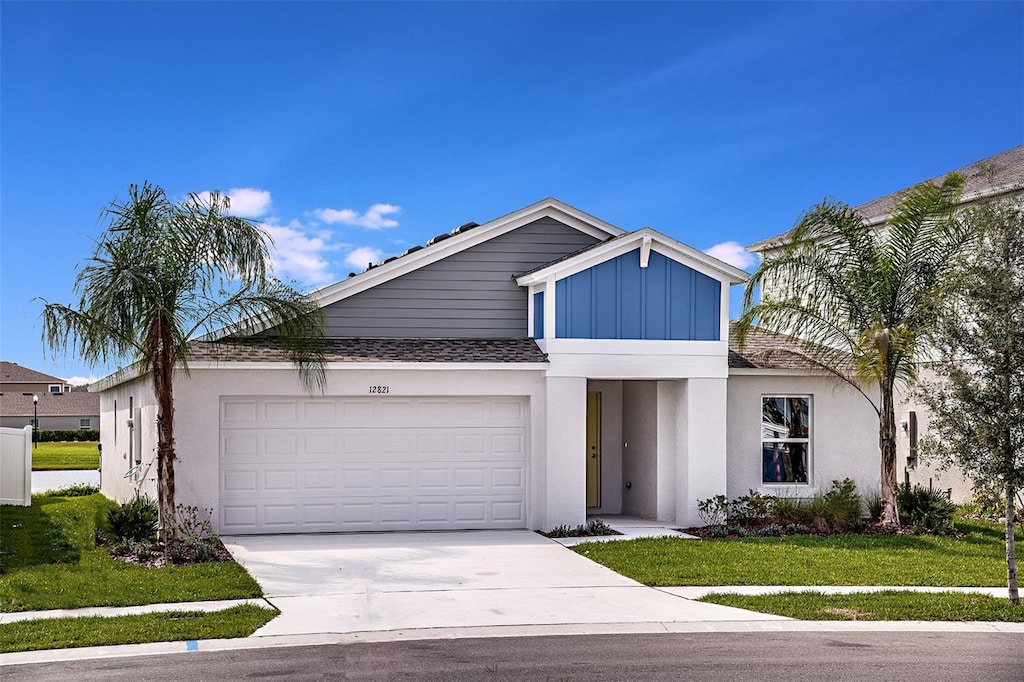 view of front of house with a garage and a front yard