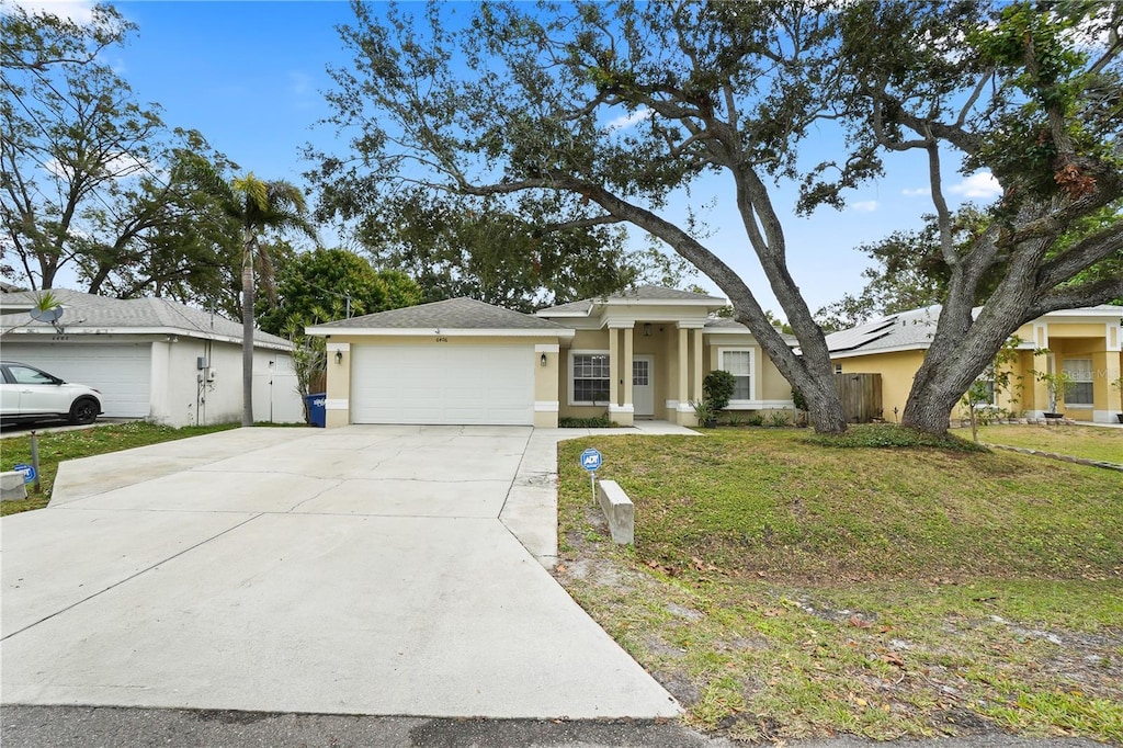 view of front of home featuring a garage and a front yard