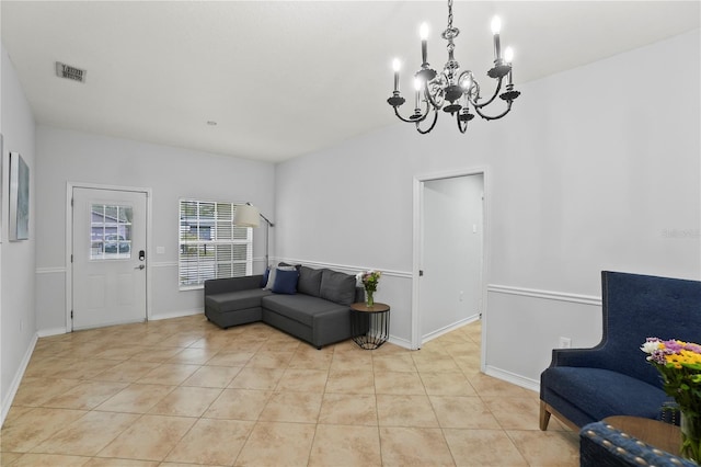 living area featuring light tile patterned floors and a chandelier