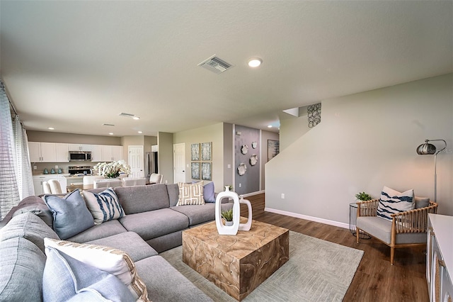 living room with dark hardwood / wood-style flooring