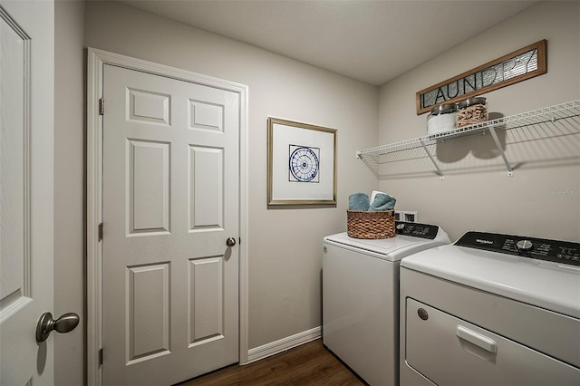 laundry area with separate washer and dryer and dark hardwood / wood-style floors