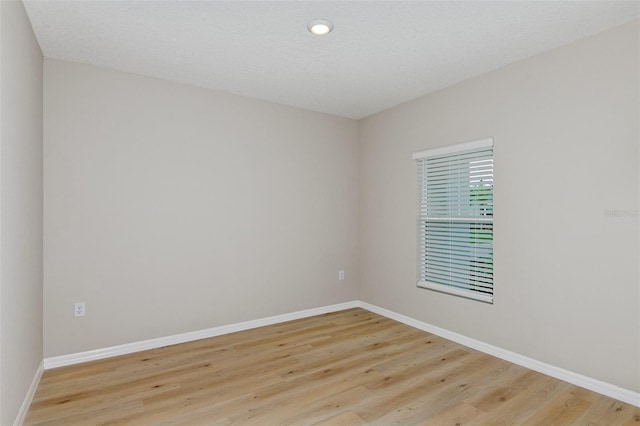 empty room with light hardwood / wood-style flooring