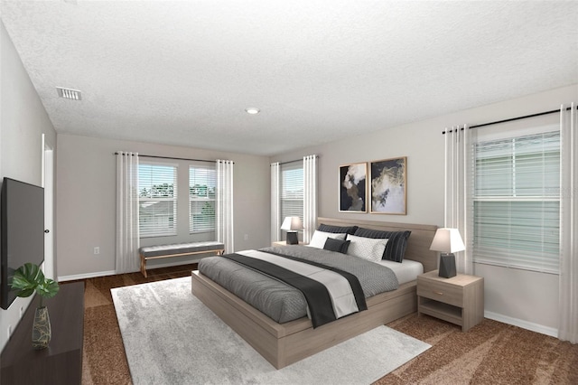 carpeted bedroom with a textured ceiling