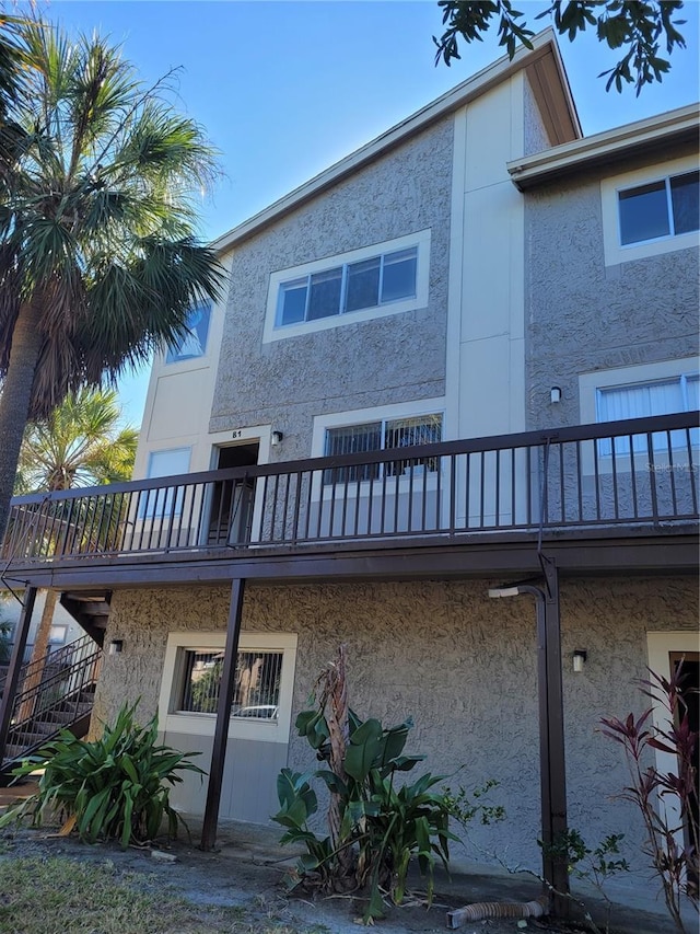 back of house featuring a balcony