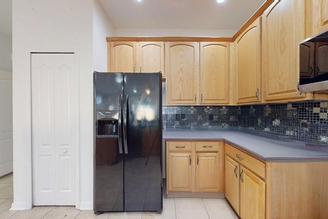 kitchen featuring light brown cabinets, black fridge with ice dispenser, light tile patterned floors, and backsplash