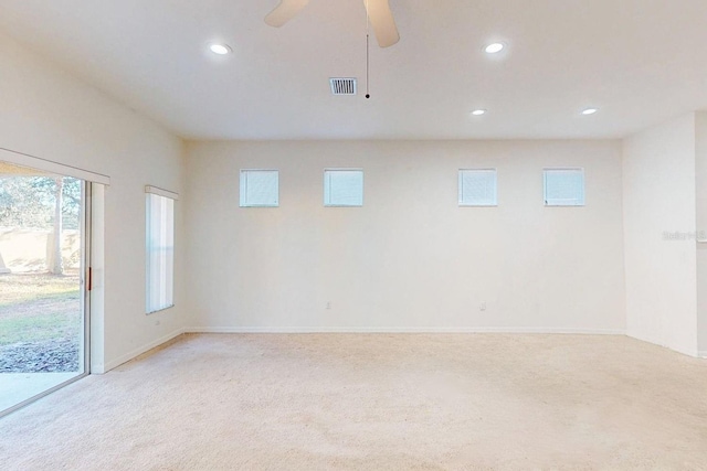 carpeted empty room featuring ceiling fan