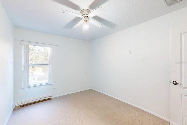 spare room featuring ceiling fan, carpet floors, and a baseboard radiator