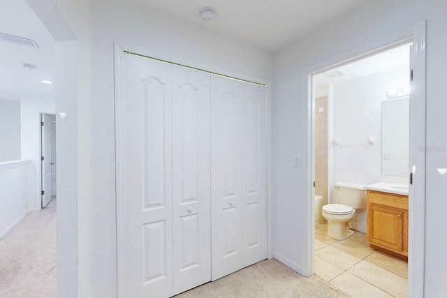 bathroom featuring tile patterned flooring, vanity, and toilet