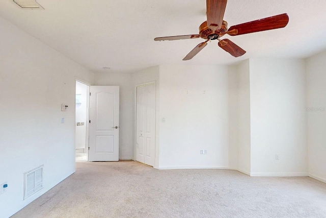 carpeted empty room with ceiling fan