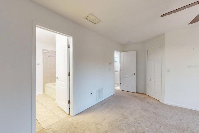 carpeted empty room featuring ceiling fan