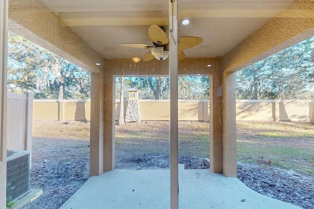 view of patio with central AC unit and ceiling fan