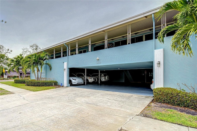 view of property featuring a carport and driveway