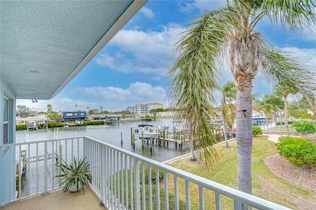 balcony featuring a water view, boat lift, and a boat dock