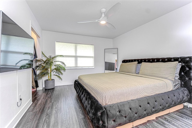 bedroom featuring ceiling fan, wood finished floors, and baseboards