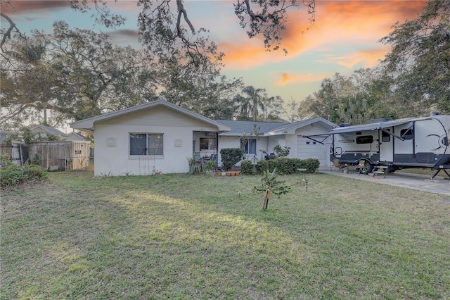 view of front facade with a carport and a yard