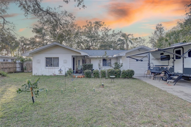 view of front of home featuring a carport and a lawn