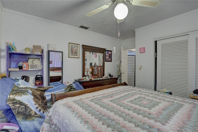 bedroom featuring ceiling fan, a closet, a textured ceiling, and ornamental molding