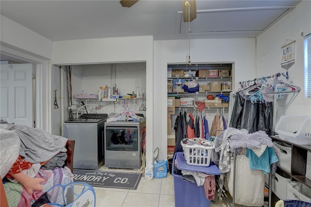 laundry area featuring washing machine and dryer, ceiling fan, and light tile patterned floors