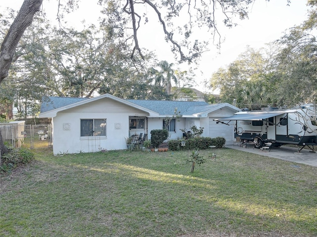 ranch-style house featuring a carport and a front lawn