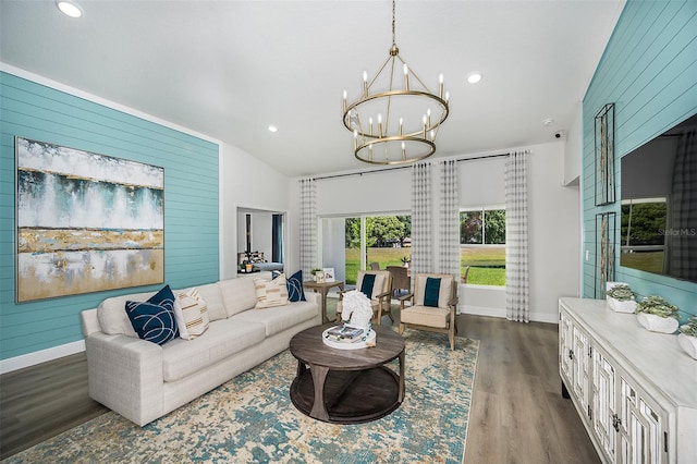 living room with an inviting chandelier, dark hardwood / wood-style flooring, and vaulted ceiling