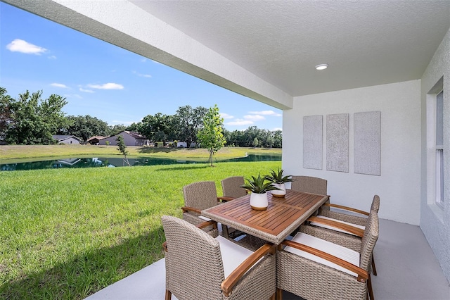 view of patio with a water view